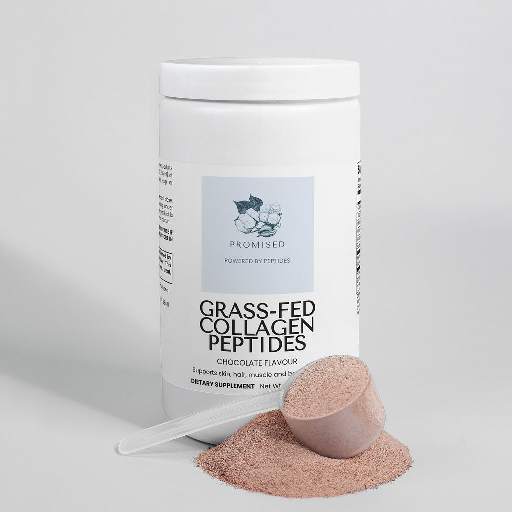 Promised chocolate grass-fed collagen peptides powder in a white tub with a scoop of brown powder on a white surface.