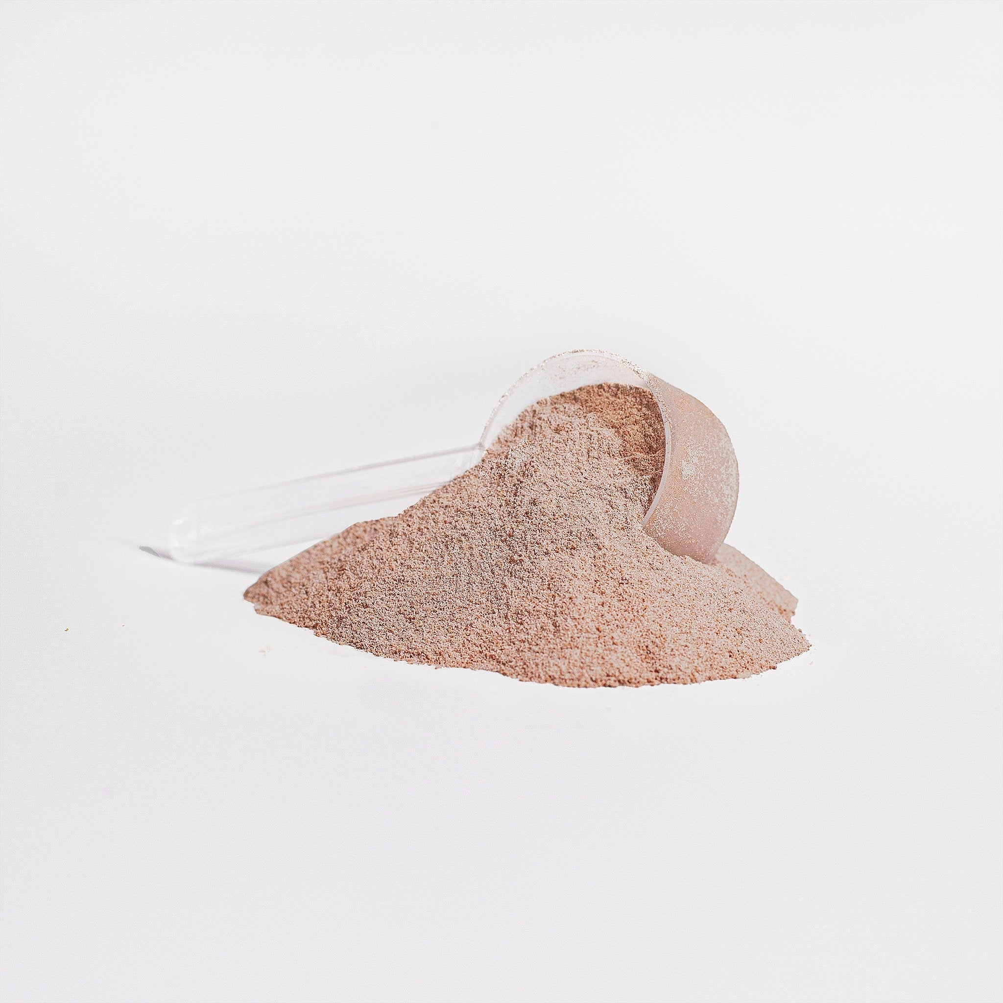 Promised chocolate grass-fed collagen peptides powder with a clear plastic scoop on a white background